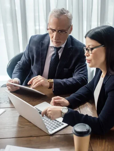 depositphotos_356400950-stock-photo-businessman-asian-businesswoman-looking-laptop